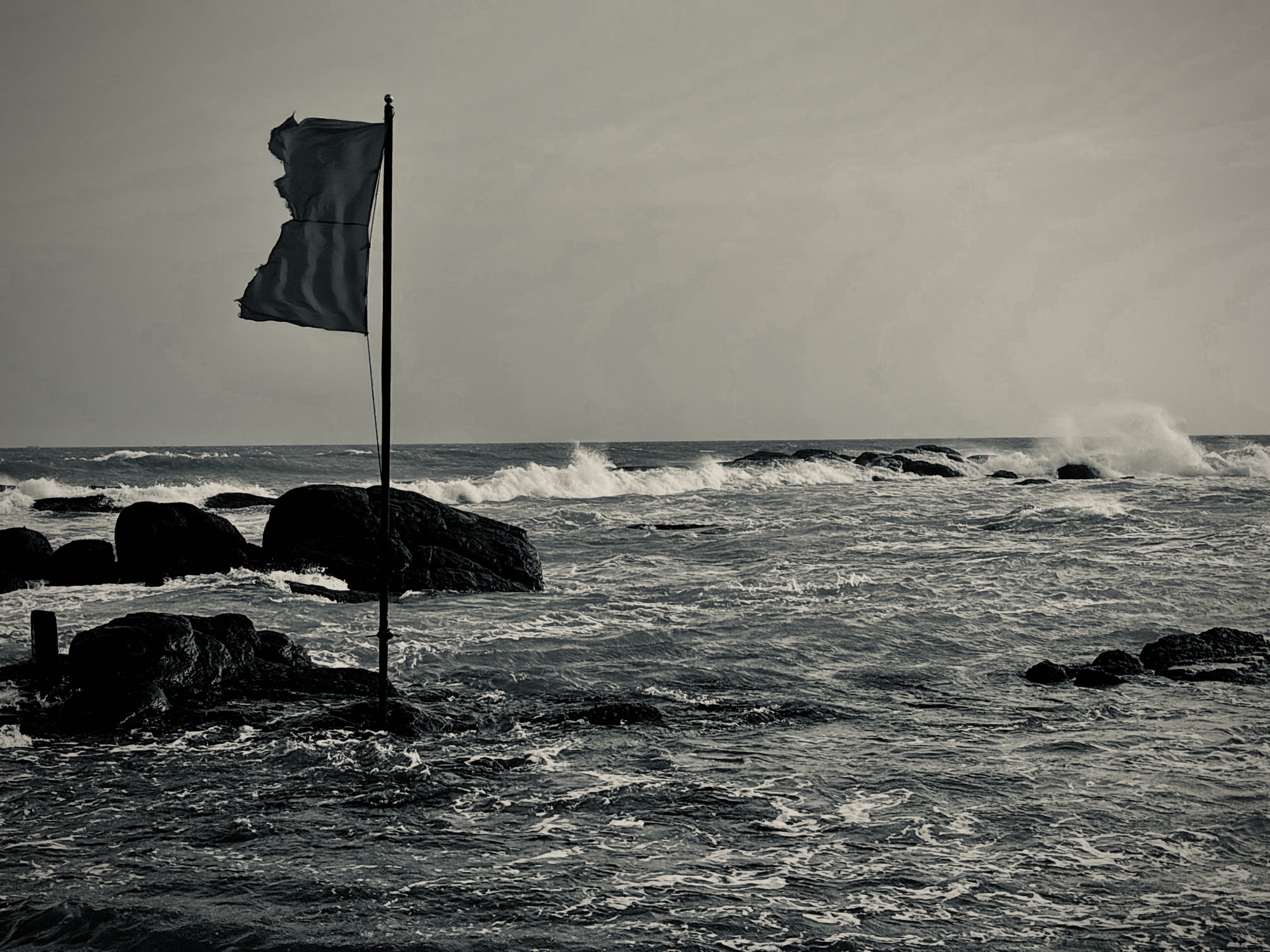 A torn flag against the swell